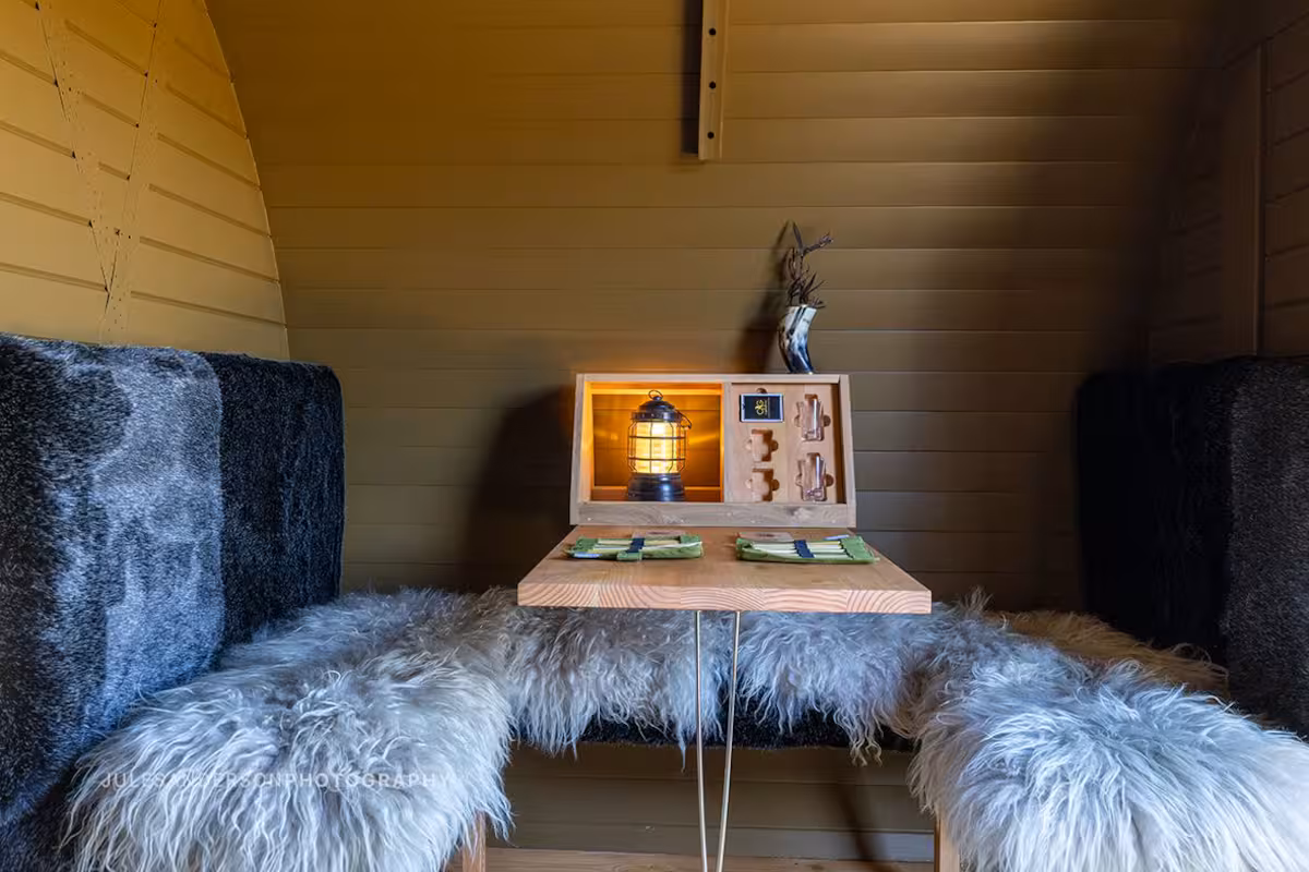 Freyja cabin outdoor deck with seating and views to the Kaiata ranges