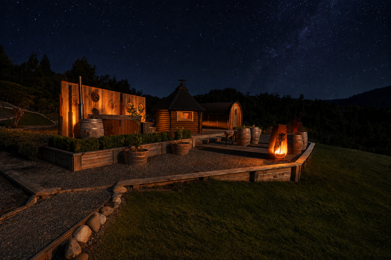 Native rainforest and barrel cabins at Kaiata beneath a clear night sky